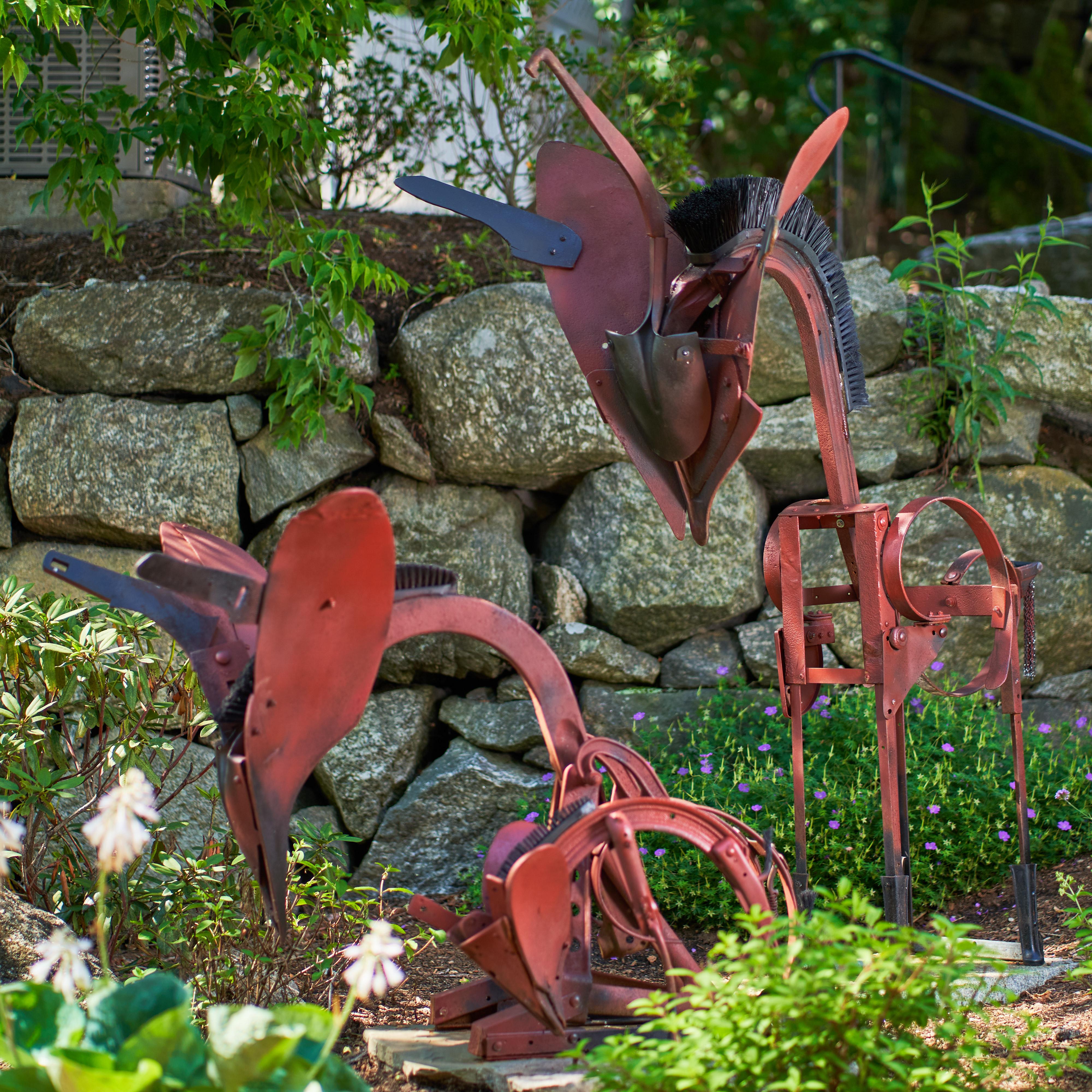Sculpture of two abstract animals crafted of cast iron, steel, stone